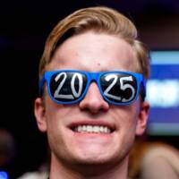 A student smiles wearing 2025 glasses